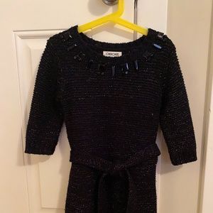 Girl’s black sweater dress with gold thread and jeweled neckline